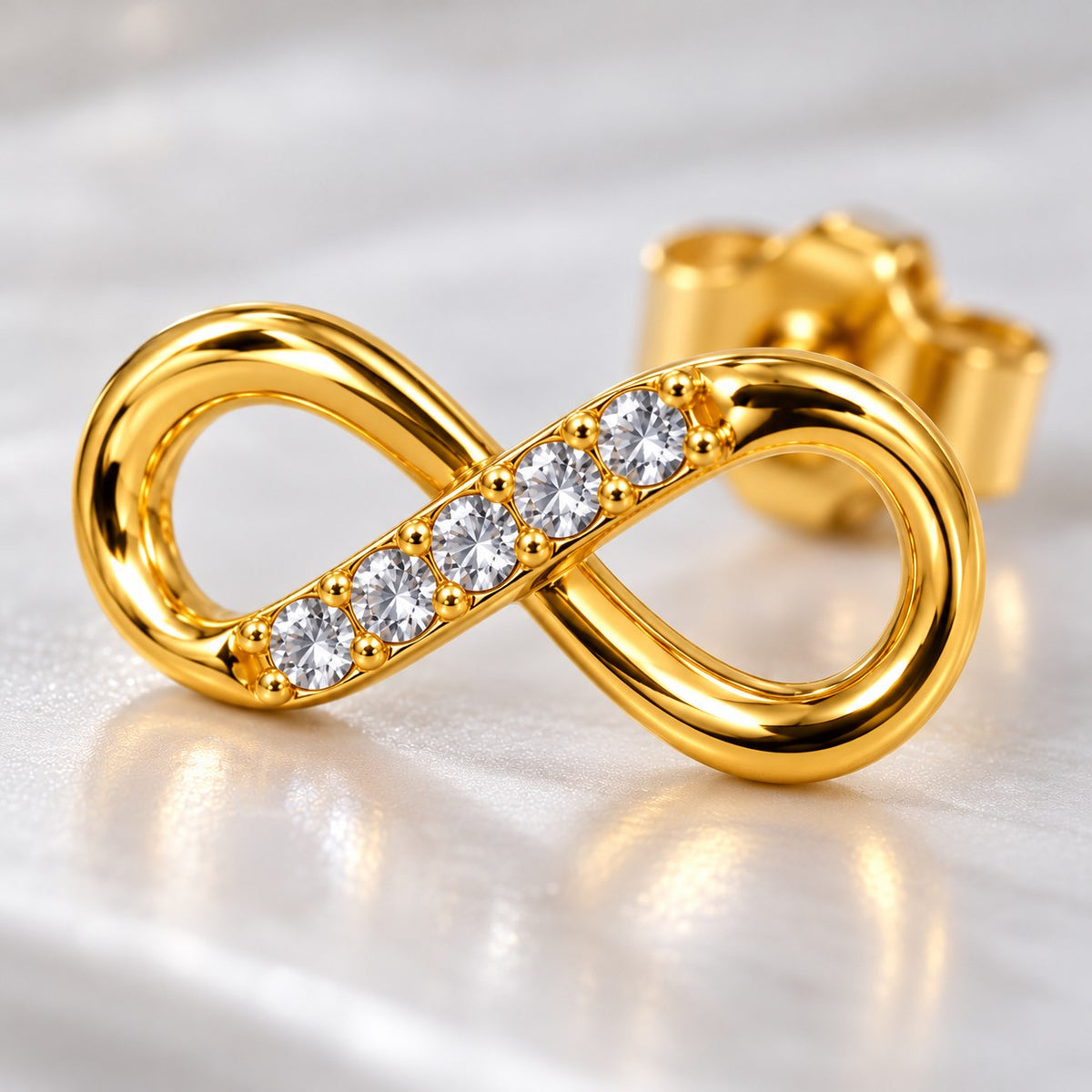 Macro view of the crystal row on a gold infinity stud earring