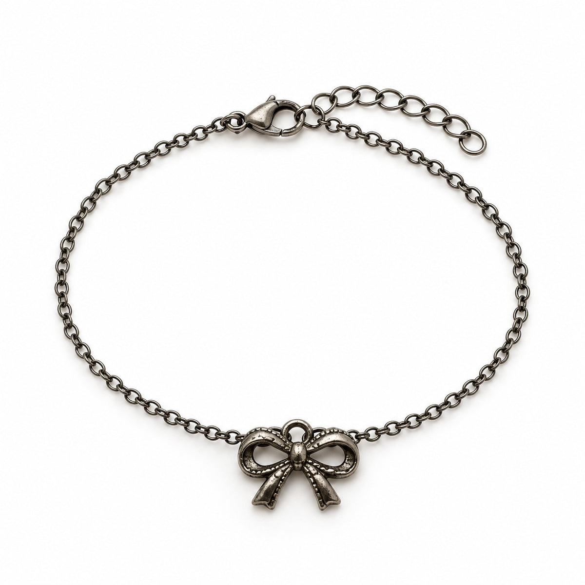 Silver bow charm bracelet with an antique ribbon bow charm on a white background