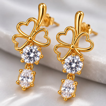 Macro view of American Diamond (CZ) stones in gold claw settings on a clover drop earring
