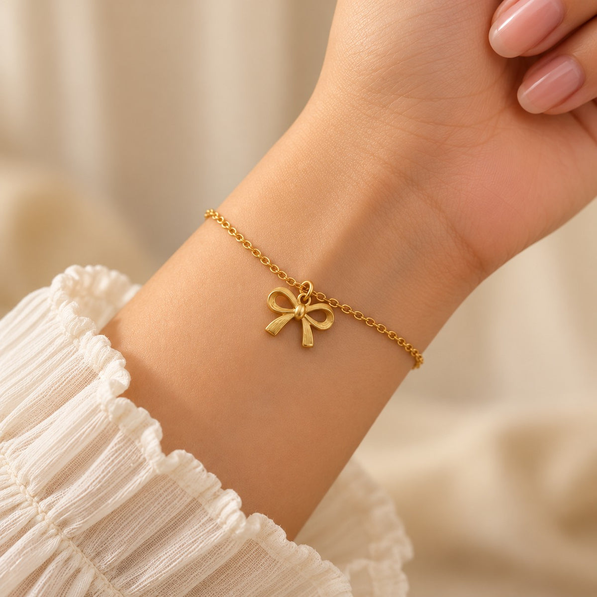 Woman wearing the gold bow charm bracelet on her wrist