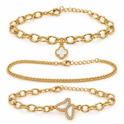 Gold clover and butterfly bracelet set of 3 laid out on a white background