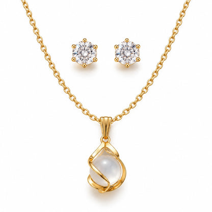 Gold moonstone pendant necklace with crystal stud earrings set on a white background