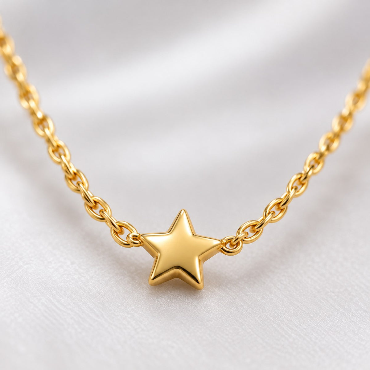 Close-up of the tiny five-point star on the gold twisted chain necklace