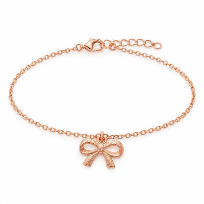 Rose gold bow charm bracelet with a ribbon bow charm on a white background
