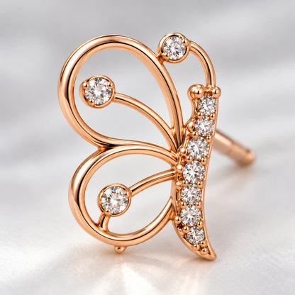 Close-up of the open-wire wings and crystal body of a rose gold butterfly stud earring