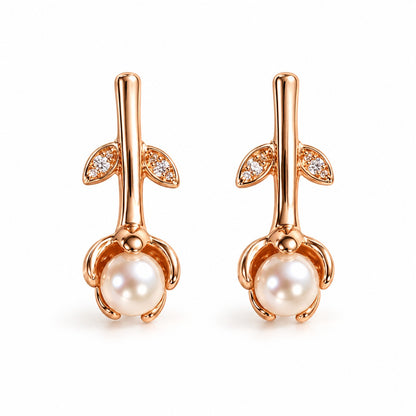 Rose gold rosebud pearl drop earrings for women on a white background