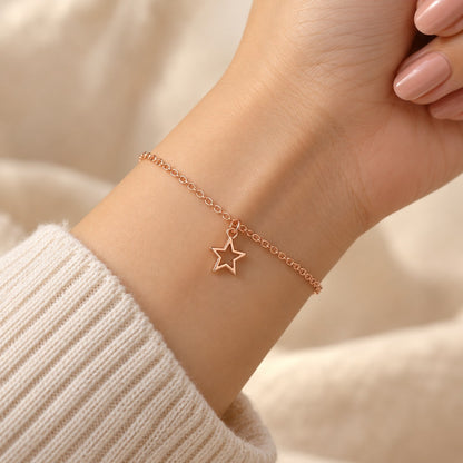 Woman wearing the rose gold star charm bracelet on her wrist