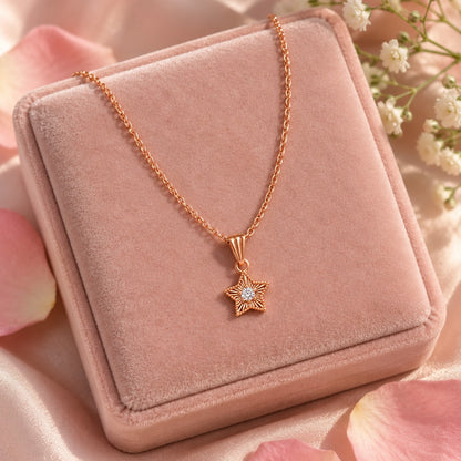 Rose gold star solitaire pendant necklace on a blush-pink velvet jewellery box