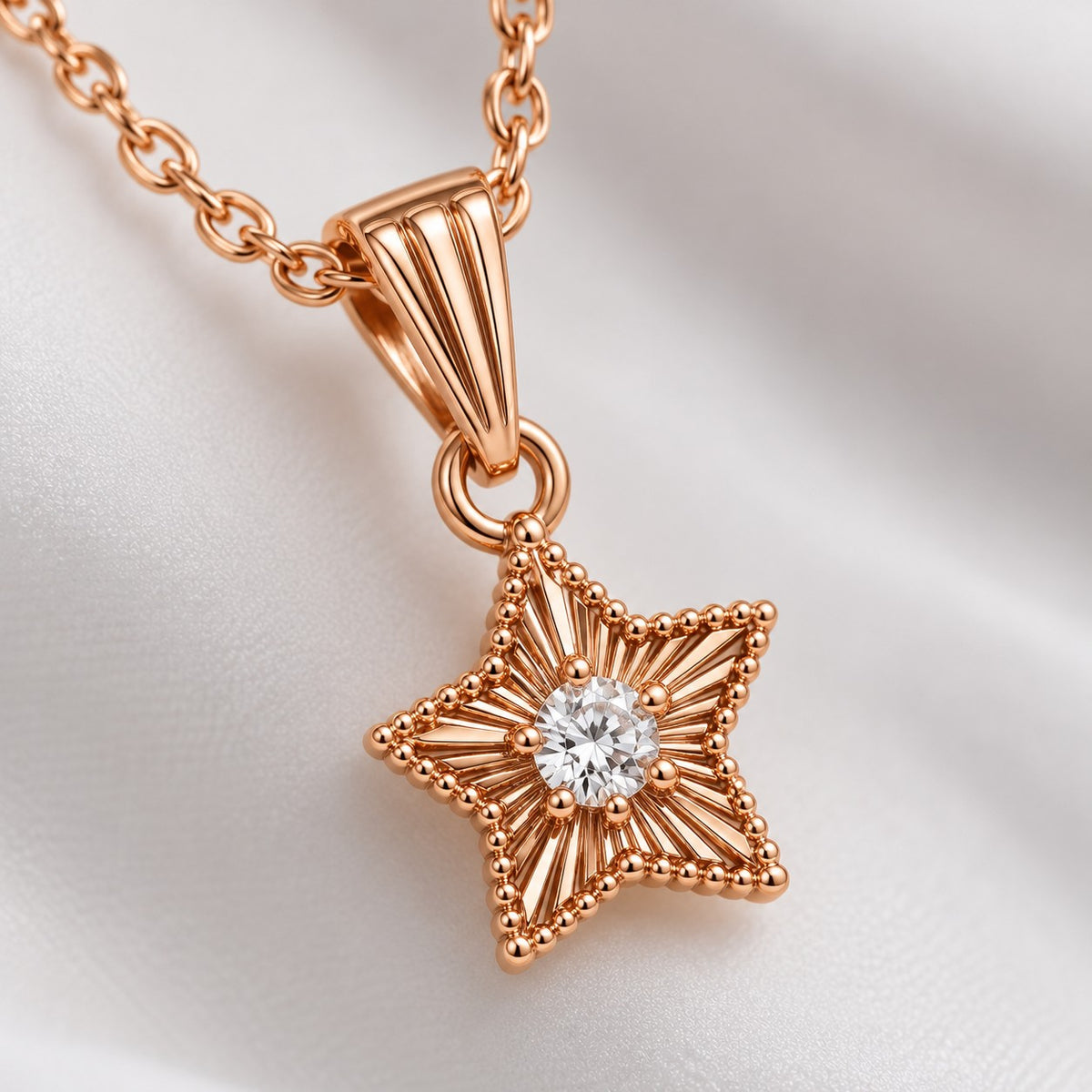 Close-up of the textured rose gold star pendant with a centre crystal