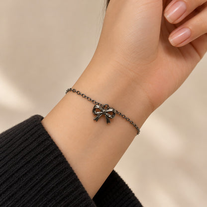 Woman wearing the silver bow charm bracelet on her wrist
