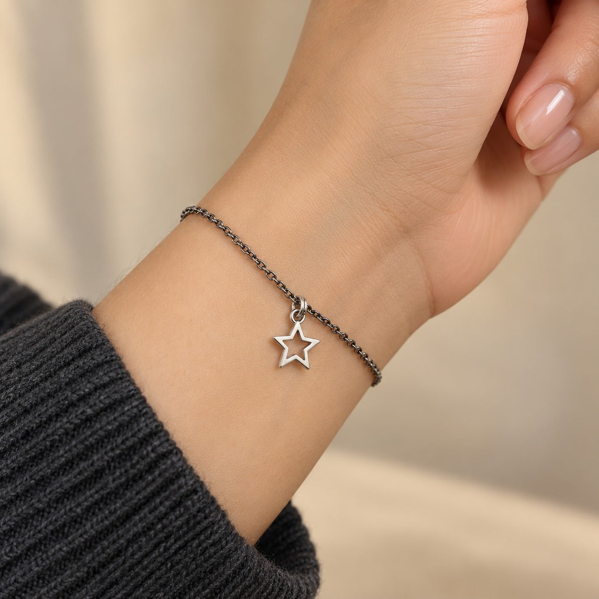 Woman wearing the silver star charm bracelet on her wrist